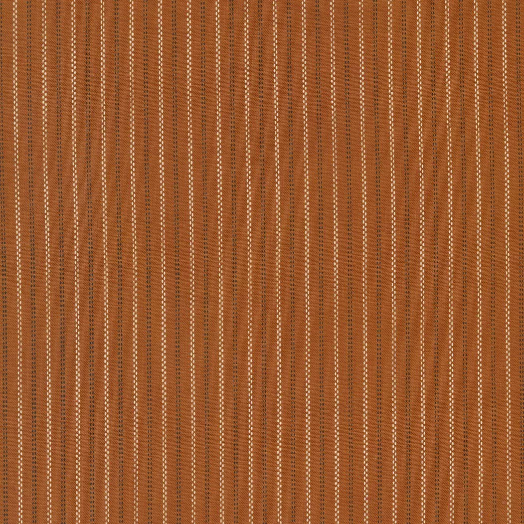 Moda Rustic Gatherings.Dashed white and black lines on a spice colored background.