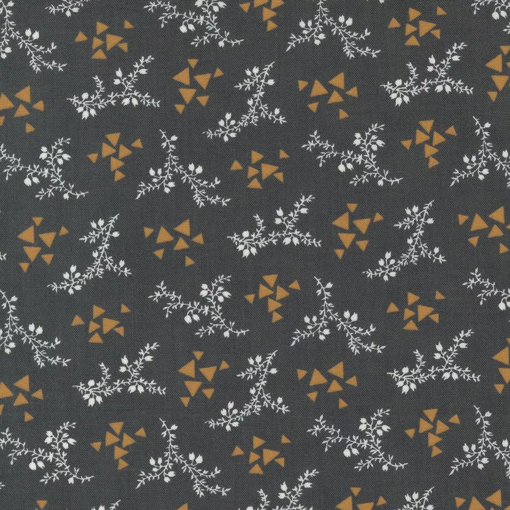 Moda Rustic Gatherings.Small white florals with amber geometric triangles on a charcoal colored background.