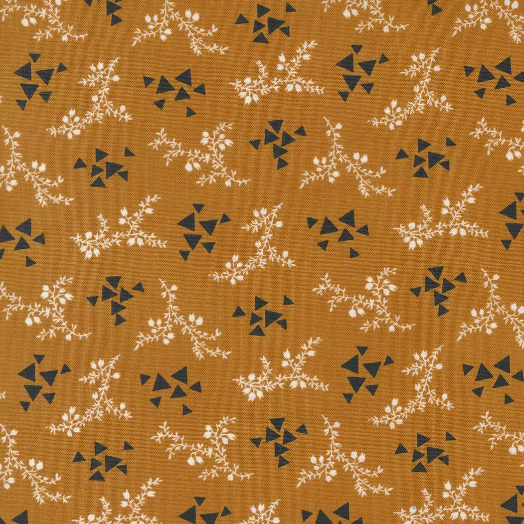 Moda Rustic Gatherings.Small white florals with black geometric triangles on a amber colored background.