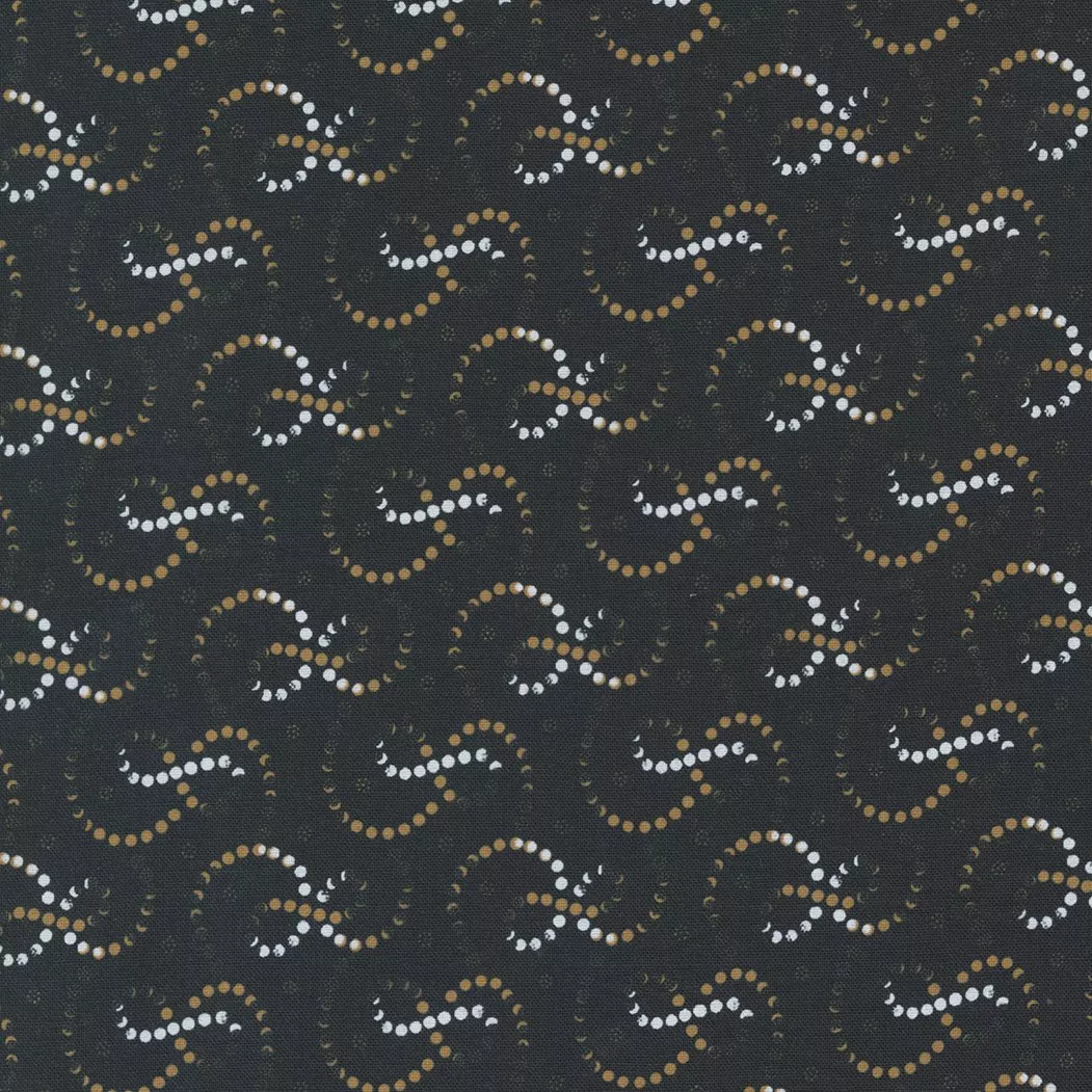 Moda Rustic Gatherings.Swirling white and amber dotted lines on a black colored background.